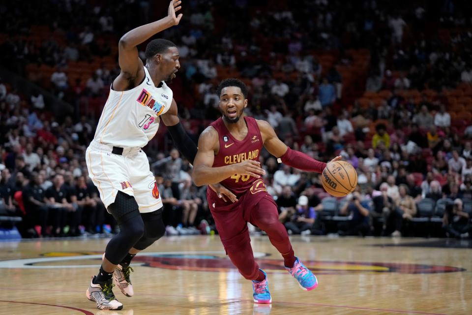 Cleveland Cavaliers guard Donovan Mitchell (45) drives to the basket against Miami Heat center Bam Adebayo (13) during the first half of an NBA basketball game, Wednesday, March 8, 2023, in Miami. (AP Photo/Wilfredo Lee)