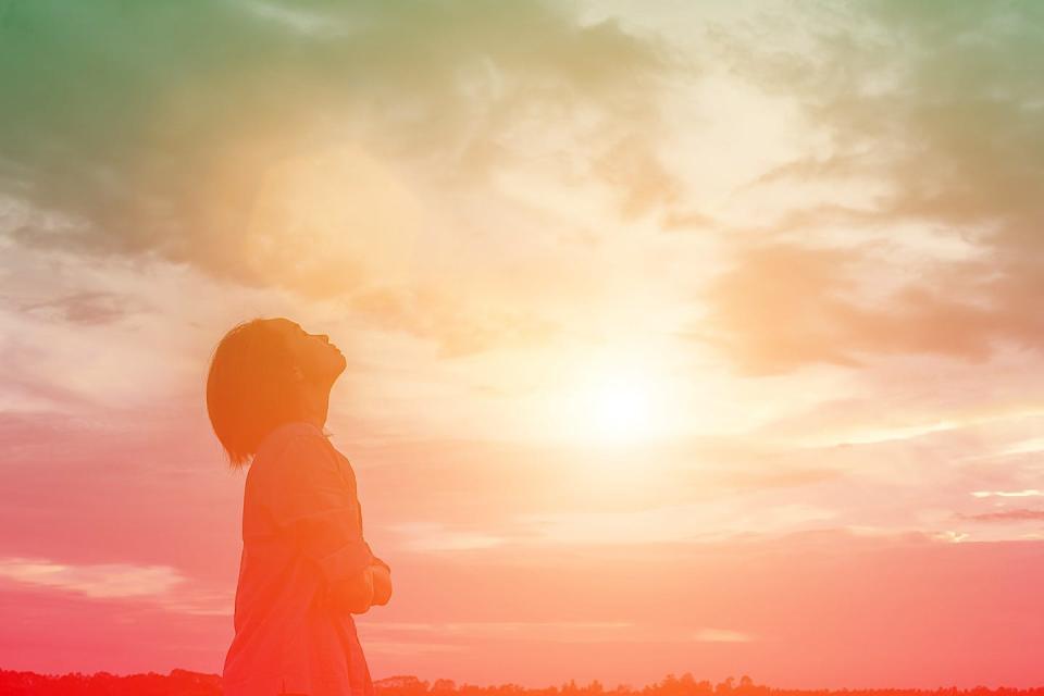 silhouette of woman over beautiful sky background