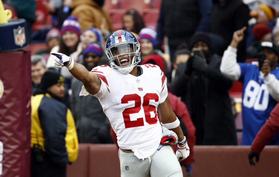 New York Giants running back Saquon Barkley (26) celebrates his 78-yard touchdown during the first half of an NFL football game against the Washington Redskins, Sunday, Dec. 9, 2018, in Landover, Md. (AP Photo/Patrick Semansky)