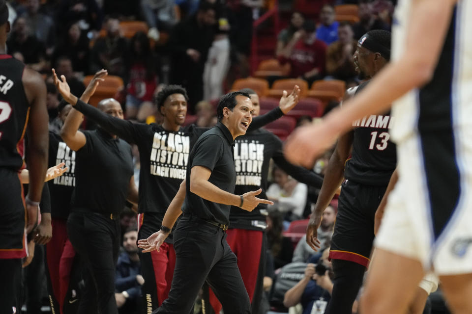 Miami Heat coach Erik Spoelstra and players celebrate during the first half of the team's NBA basketball game against the Orlando Magic, Tuesday, Feb. 6, 2024, in Miami. (AP Photo/Rebecca Blackwell)