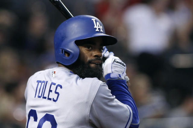 Los Angeles Dodgers' Andrew Toles (60) walks off the field after