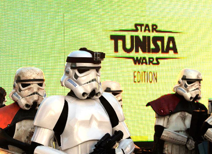 Star Wars fan dressed as stormtroopers parade along Tunis’ stately, tree-lined Bourguiba Avenue, in Tunisia, Wednesday, April 30, 2014. The empire was not striking back against the poster child for Arab democracy — just an innovative campaign to encourage tourists to return to this sunny desert-and-beach nation in North Africa. "We came here to Tunis to help save the Star Wars sites in Matmata and Tozeur and convince people to return to Tunisia," said Ingo Kaiser, head of a Star Wars fan club in Europe, referring to the movie sets that are slowly being covered up by sand in the Tunisian desert. (AP Photo/Aimen Zine)