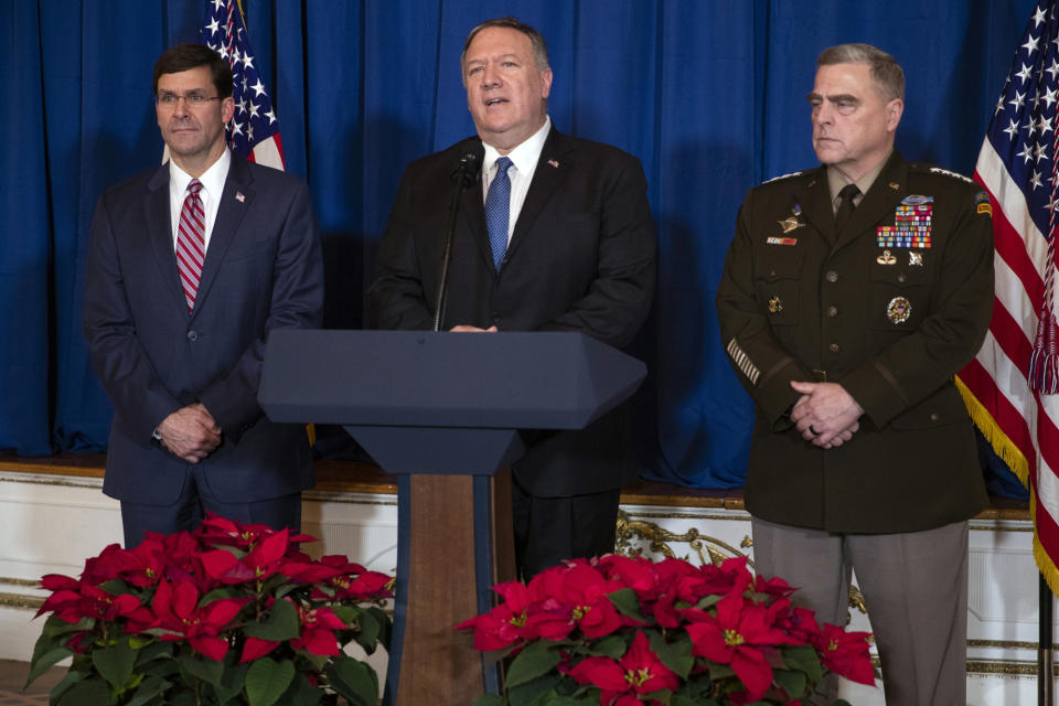 Secretary of Defense Mark Esper, left, and Chairman of the Joint Chiefs of Staff Gen. Mark Milley, right, listen as Secretary of State Mike Pompeo delivers a statement on Iraq and Syria, at President Donald Trump's Mar-a-Lago property, Sunday, Dec. 29, 2019, in Palm Beach, Fla. (AP Photo/ Evan Vucci)