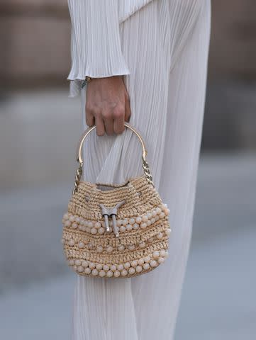 A guest is seen wearing Loewe basket bag outside William Fan during News  Photo - Getty Images