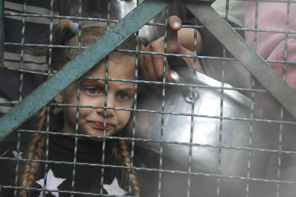 Palestinians line up to receive free meals at Jabaliya refugee camp in the Gaza Strip on Monday, March 18, 2024. (AP Photo/Mahmoud Essa)