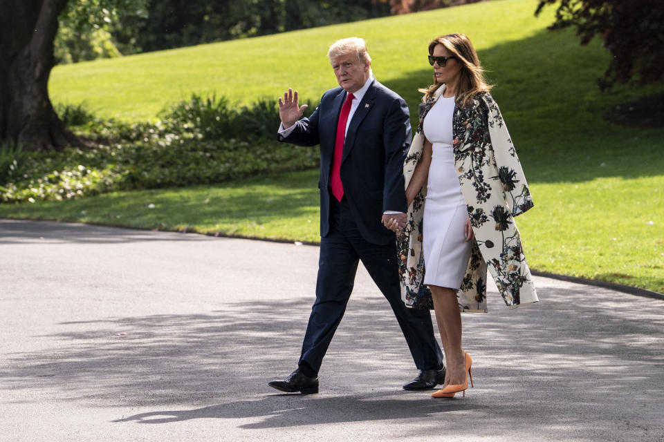 Melania Trump wore a fitted white dress and a black and white floral coat to arrive in Fort Bragg to greeet soldiers. [Photo: PA]