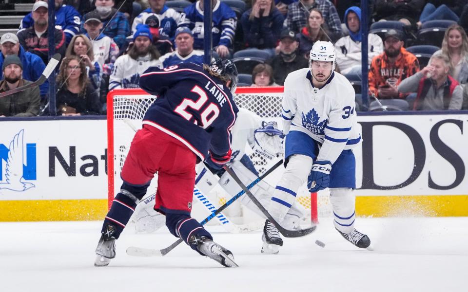 Columbus Blue Jackets left wing Patrik Laine (29) scores the game-winning goal past Toronto Maple Leafs center Auston Matthews (34) during overtime of the NHL hockey game at Nationwide Arena in Columbus on Feb. 22, 2022. The Blue Jackets won 4-3 in overtime.