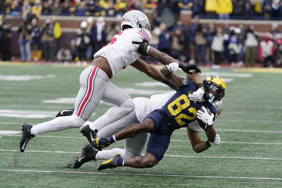 FILE - Michigan receiver Semaj Morgan (82) is tackled by Ohio State safety Sonny Styles (6) and defensive end JT Tuimoloau (44) during the second half of an NCAA college football game, Saturday, Nov. 25, 2023, in Ann Arbor, Mich. Ninth-ranked Missouri is in its first New Year’s Six game during the four-team College Football Playoff era against seventh-ranked Ohio State in the Cotton Bowl. (AP Photo/Carlos Osorio, File)