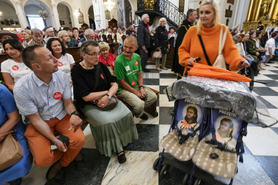 Polish families take part in a Catholic Mass concluding the March for Life and Family, an annual march against abortion and in support of conservative values, in Warsaw, Poland, on Sunday June 18, 2023. The march was held a day after the city's large Pride parade, and reflects a show for conservative Catholic values as the Pride parades have grown larger and more numerous. (AP Photo/Czarek Sokolowski)