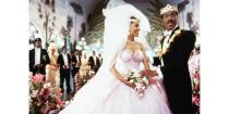 <p>What to wear when you suddenly become a princess? Lisa McDowell, played by Shari Headley, nailed her wedding dress to Prince Akeem with a light pink strapless tulle ball gown and gold crown for the ceremony. </p>