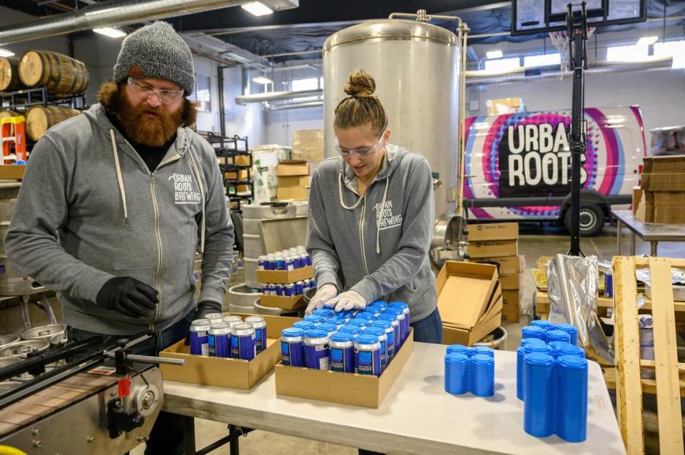 Peter Salmond, brewer, and Alli Okumura pack canned beer at Urban Roots Brewery & Smokehouse on Thursday Jan. 29, 2019 in Sacramento. Hector Amezcua/hamezcua@sacbee.com