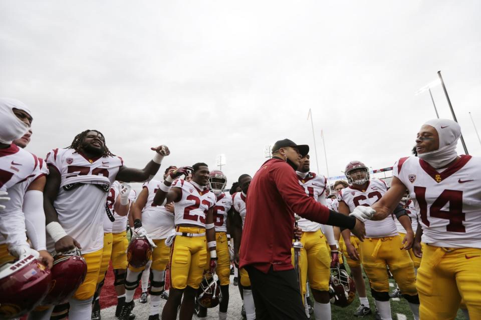 USC interim head coach Donte Williams, center, celebrates with his players.