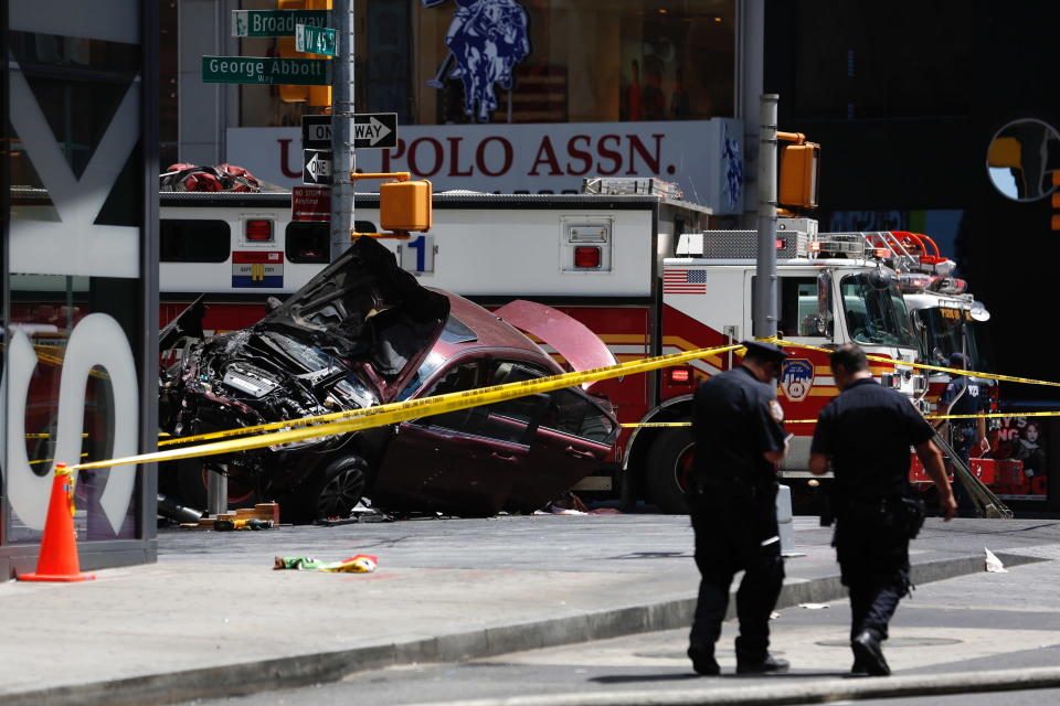 FILE- A smashed car sits on the corner of Broadway and 45th Street in New York's Times Square, May 18, 2017, after the car was driven into a crowd of pedestrians. Prosecutors are largely relying on the testimony of victims to make a case against Rojas that could put him behind bars for decades. His lawyers are saying he had a mental breakdown that day and had no capacity to understand what he was doing. (AP Photo/Seth Wenig, File)