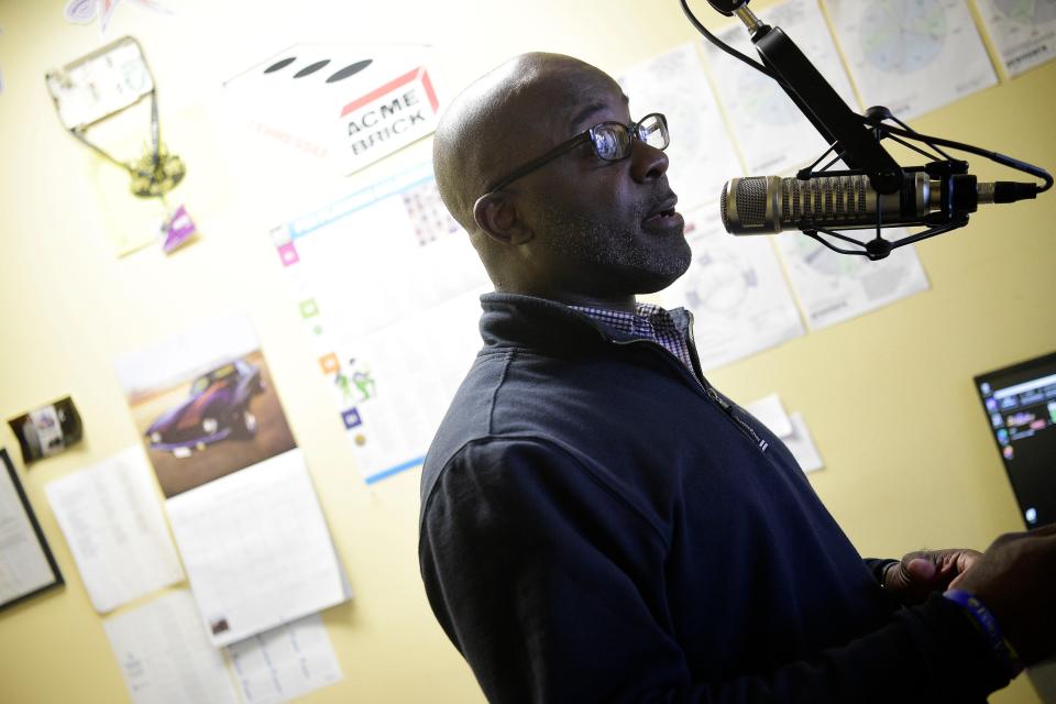 Program Director Gene Thomas speaks into the microphone in his booth at WJBE in Five Points in Knoxville, Tenn. on Thursday, Jan. 28, 2021.