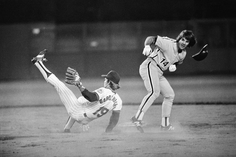 Pete Rose of the Philadelphia Phillies staggers after crashing into New York Mets shortstop Ron Gardenhire on the base path at Shea Stadium, Sept. 17, 1981, New York.