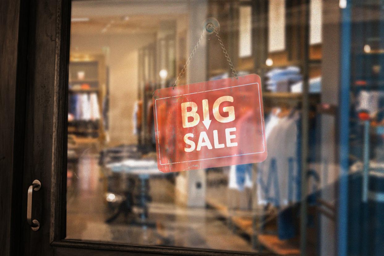 'big sale' sign in clothing store window door