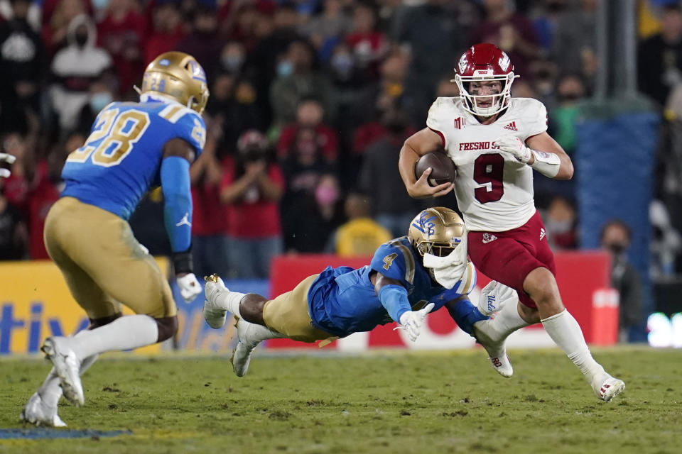 Fresno State quarterback Jake Haener (9) runs past UCLA defensive back Stephan Blaylock (4) during the second half of an NCAA college football game Sunday, Sept. 19, 2021, in Pasadena, Calif. (AP Photo/Marcio Jose Sanchez)