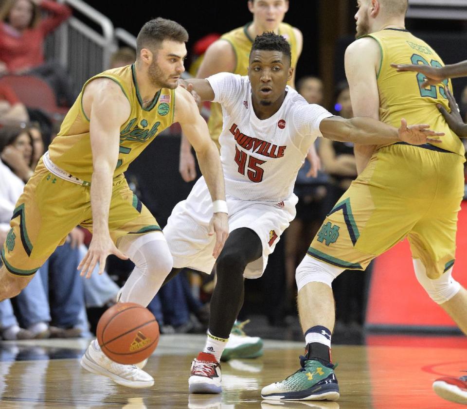 Notre Dame's Matt Farrell (5) attempts to drive past the defense of Louisville's Donovan Mitchell (45) during the second half of an NCAA college basketball game, Saturday, March 4, 2017, in Louisville, Ky. Louisville won 71-64. (AP Photo/Timothy D. Easley)