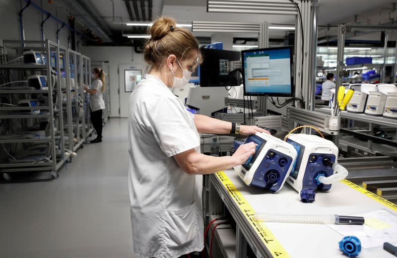 FILE PHOTO: Employees of Hamilton Medical AG test ventilators at a plant in Domat/Ems