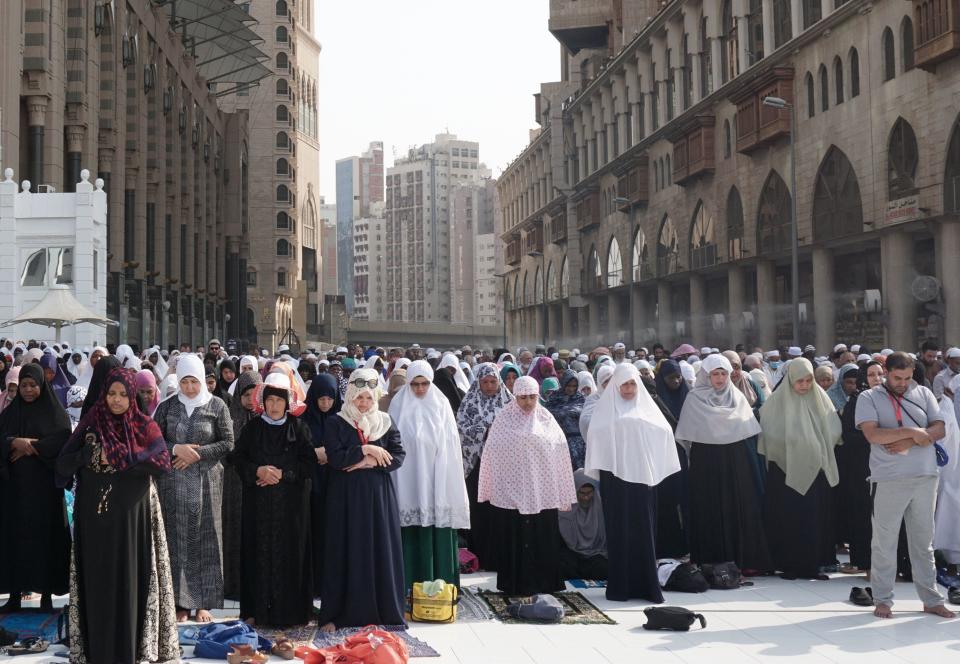 Muslim worshippers pray outside the Grand Mosque in the holy city of Mecca in Saudi Arabia.