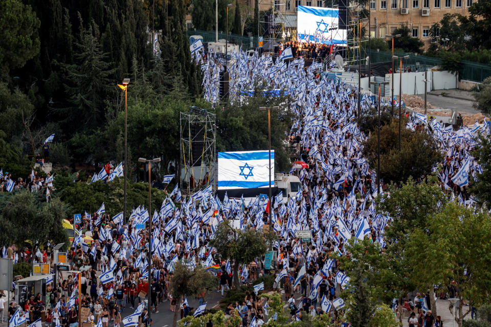 Protesters gather outside the Knesset following a vote on a contested bill that limits Supreme Court powers to void some government decisions