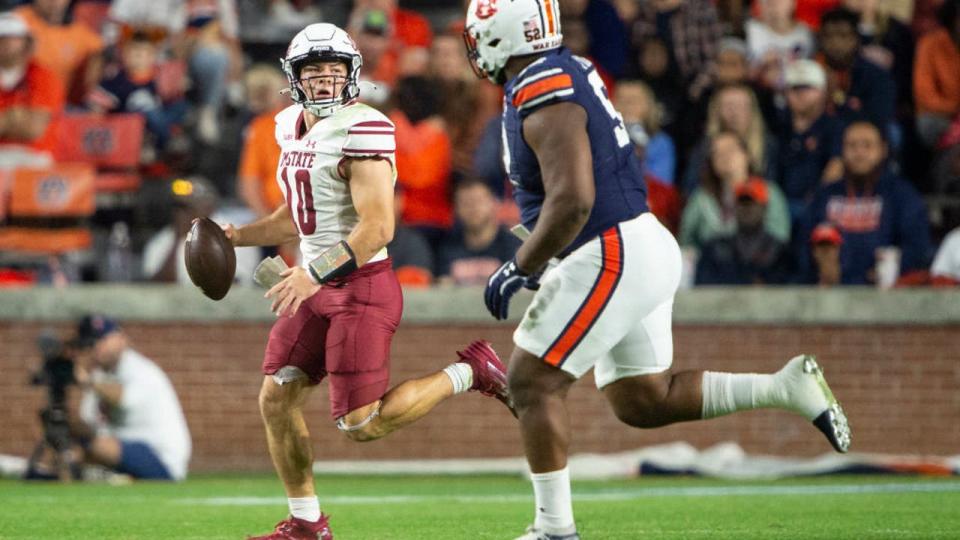 <div>AUBURN, ALABAMA - NOVEMBER 18: Quarterback Diego Pavia #10 of the New Mexico State Aggies looks to throw the ball over defensive lineman Justin Rogers #52 of the <a class="link " href="https://sports.yahoo.com/ncaaf/players/405437/" data-i13n="sec:content-canvas;subsec:anchor_text;elm:context_link" data-ylk="slk:Auburn Tigers;sec:content-canvas;subsec:anchor_text;elm:context_link;itc:0">Auburn Tigers</a> during the second half of play at Jordan-Hare Stadium on November 18, 2023 in Auburn, Alabama. (Photo by Michael Chang/Getty Images)</div>