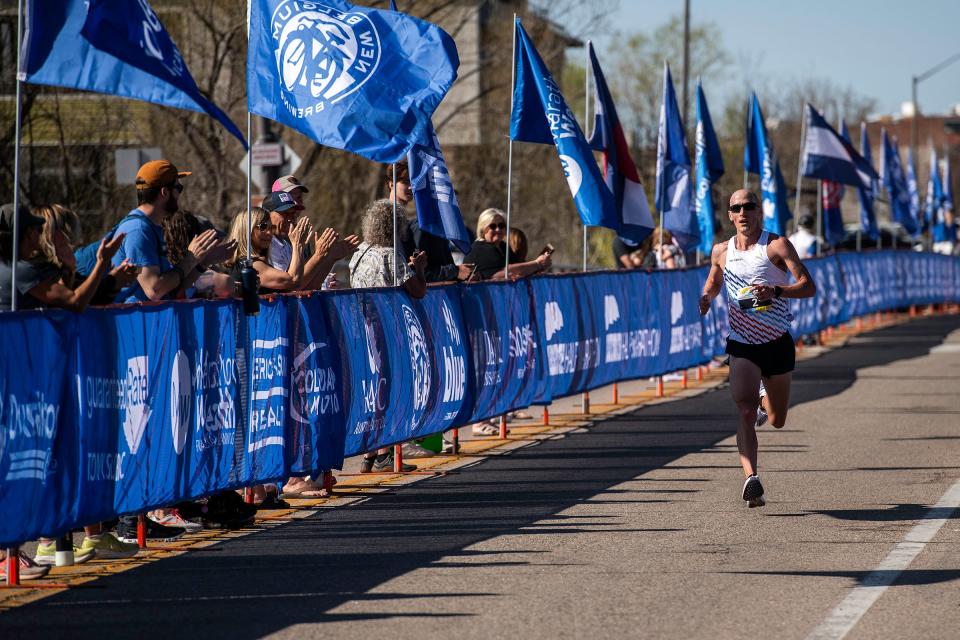 Tyler McCandless comes down the last stretch before crossing the finish line in second place during the Horsetooth Half Marathon on Sunday in Fort Collins.