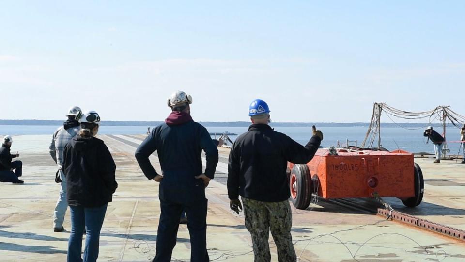 Sailors assigned to the pre-commissioning unit John F. Kennedy  work alongside HII and Naval Air Systems Command counterparts during the first “dead-load” testing of the electromagnetic aircraft launch system (EMALS). (MC2 Alexander Timewell/U.S. Navy)