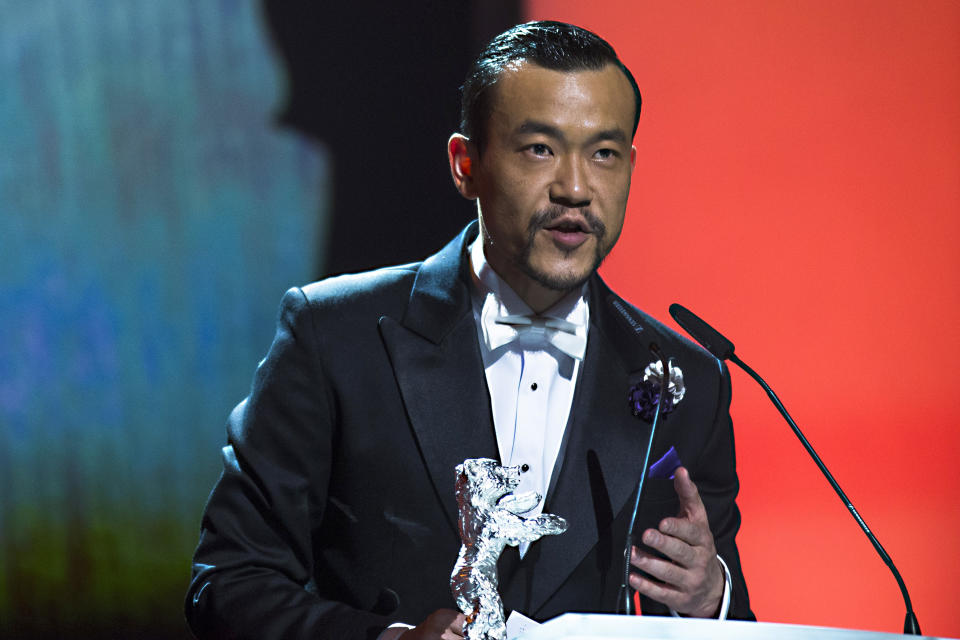 Actor Liao Fan receives the Silver Bear for best actor in the movie Black Coal, Thin Ice during the award ceremony at the International Film Festival Berlinale in Berlin, Saturday, Feb. 15, 2014. (AP Photo/Axel Schmidt)