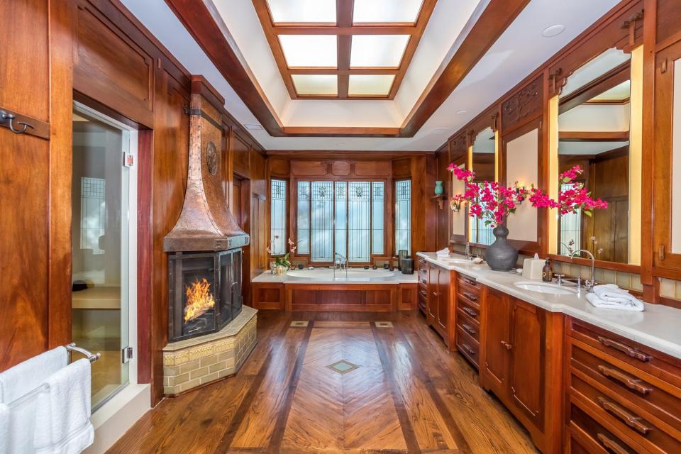 Bathroom with wooden features and a fireplace