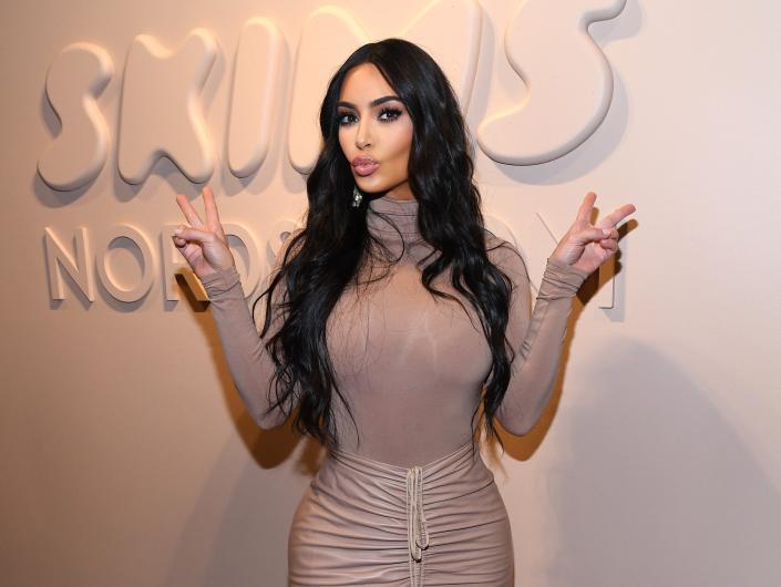 Kim Kardashian with a Skims sign.