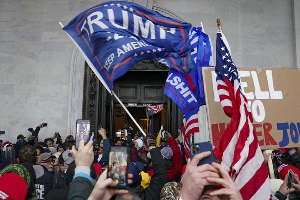 FILE - Rioters break into the Capitol in Washington, on Jan. 6, 2021. A far-right internet personality has pleaded guilty to joining the mob that stormed the U.S. Capitol, where he streamed live video that incriminated him and other rioters. Court records show that Anthime Gionet, known as "Baked Alaska" to his social media followers, faces a maximum sentence of six months imprisonment after pleading guilty on Friday, July 22, 2022. (AP Photo/John Minchillo, File)