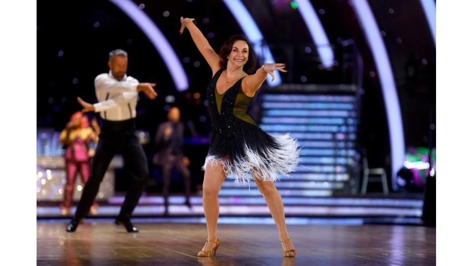 Shirley Ballas dancing in a frilly black dress