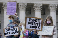 Students demonstrate during a rally to call on New York Mayor Bill de Blasio to keep schools open, Saturday, Nov. 14, 2020, in New York. Students, parents and teachers continued anxiously watching New York City's coronavirus test results as the latest figures Saturday, Nov. 14, 2020, fell under the city's threshold for shutting down school buildings, but Mayor Bill de Blasio warned that the city was at a "crucial" point in fighting the virus' resurgence. (AP Photo/Mary Altaffer)