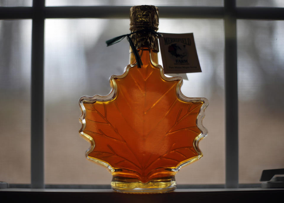 In this March 9, 2016, file photo, a bottle of maple syrup is displayed at the Merrifield Farm and Sugar Shack in Gorham, Maine. The coronavirus pandemic forced some states to cancel their annual maple season celebrations in 2020, but some New England producers with safety precautions in place are welcoming back the public in 2021. (AP Photo/Robert F. Bukaty, FIle)