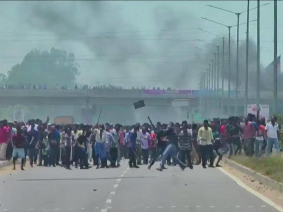 People throw stones during the protest (ANI via Reuters)