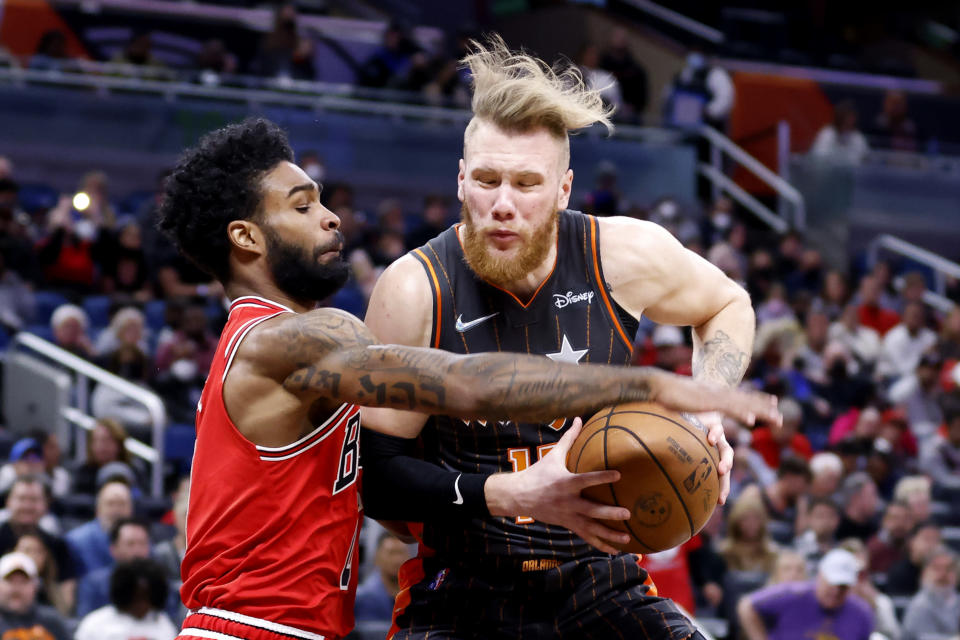 Chicago Bulls guard Coby White, left, keeps Orlando Magic forward Ignas Brazdeikis from the basket in the first quarter of an NBA basketball game, Sunday, Jan. 23, 2022, in Orlando, Fla. (AP Photo/Joe Skipper)