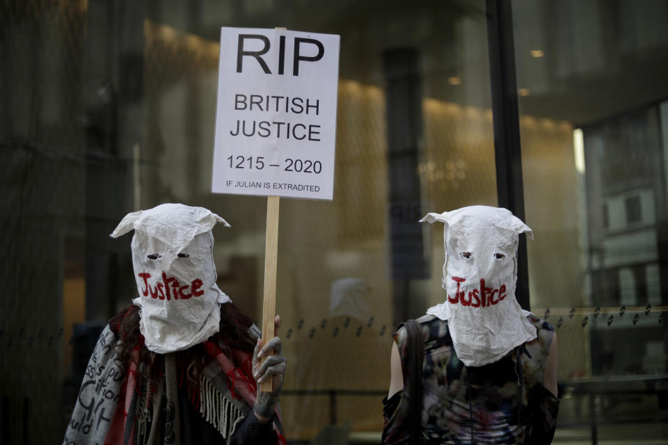 Supporters of WikiLeaks founder Julian Assange take part in a protest outside the Central Criminal Court, the Old Bailey, in London, Monday, Sept. 14, 2020. The London court hearing on Assange's extradition from Britain to the United States resumed Monday after a COVID-19 test on one of the participating lawyers came back negative, WikiLeaks said Friday. (AP Photo/Matt Dunham)