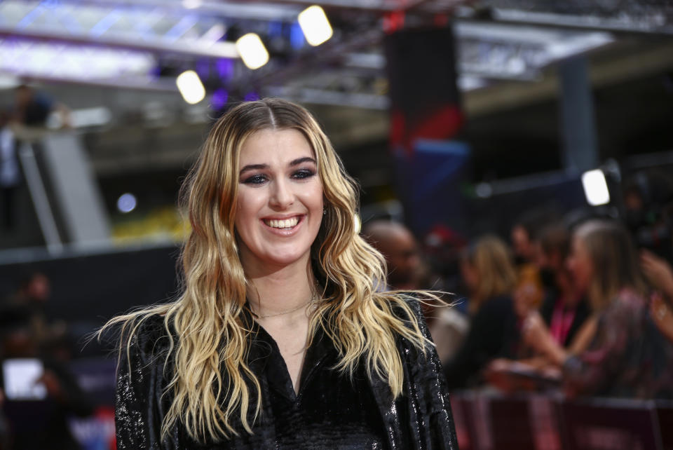 Honor Swinton Byrne poses for photographers upon arrival at the premiere of the film 'Souvenir Part II' during the 2021 BFI London Film Festival in London, Friday, Oct. 8, 2021. (Photo by Joel C Ryan/Invision/AP)