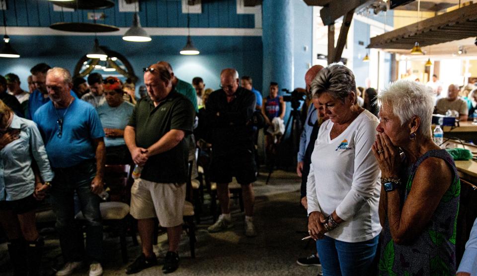 Fort Myers Beach residents take a moment during a meeting at the old Skip One building on San Carlos Boulevard on Thursday, Oct. 20, 2022. It was first town council meeting since Hurricane Ian made landfall. It was an emotionally charged meeting with some residents showing frustration about the response.  On the right is Fort Myers Beach resident, Ellen Vaugh.  