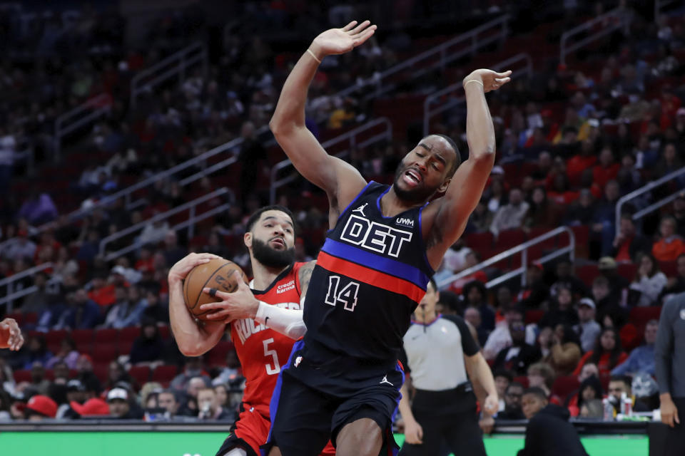 Houston Rockets guard Fred VanVleet pulls back on a drive to the basket as Detroit Pistons guard Alec Burks (14) tries to avoid fouling during the first half of an NBA basketball game, Monday, Jan. 1, 2024, in Houston. (AP Photo/Michael Wyke)