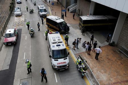 Armed policemen guard the entrance as a prison car carrying British former banker Rurik Jutting enters High Court in Hong Kong, China October 25, 2016. REUTERS/Bobby Yip