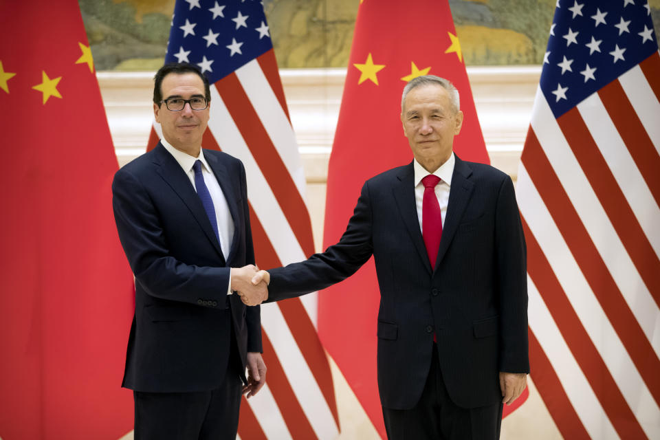 U.S. Treasury Secretary Steven Mnuchin, left, and Chinese Vice Premier and lead trade negotiator Liu He shake hands as they pose for a photo before the opening session of trade negotiations at the Diaoyutai State Guesthouse in Beijing, Thursday, Feb. 14, 2019. (AP Photo/Mark Schiefelbein, Pool)