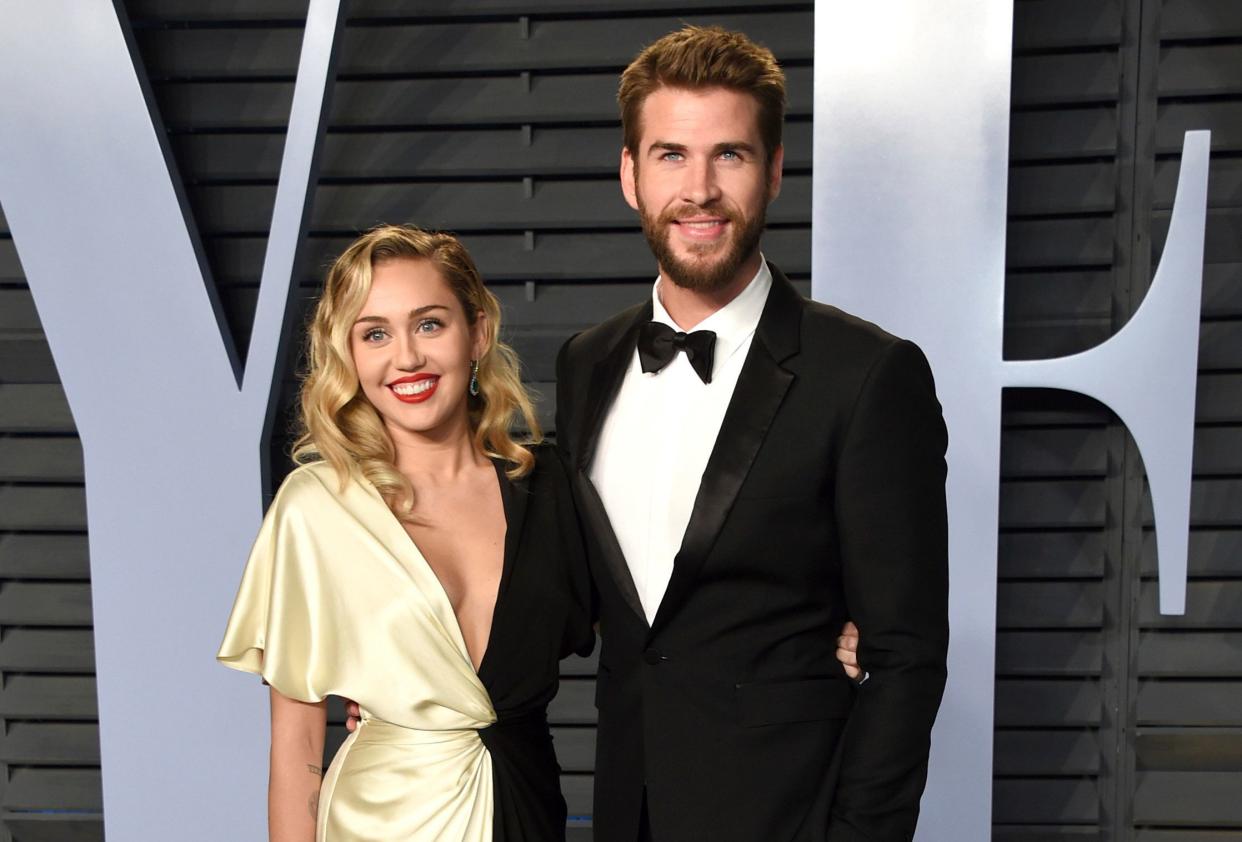 Miley Cyrus and Liam Hemsworth arrive at the Vanity Fair Oscar Party on March 4.&nbsp; (Photo: Evan Agostini/Invision/AP)