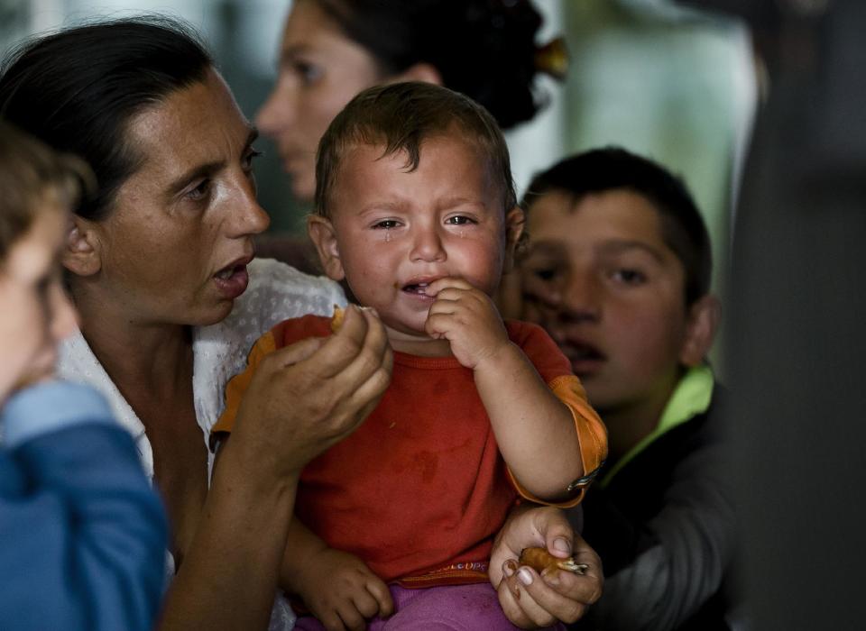 A Romanian Roma woman expelled from France feeds a crying baby at Bucharest's Henri Coanda international airport in Otopeni, Romania, Thursday, Sept. 13, 2012. French Interior Minister Manual Valls,on a two-day official visit to Romania, discuss with Romanian authorities the issue of Roma immigration to France and ways to support Roma inclusion. (AP Photo/Vadim Ghirda)