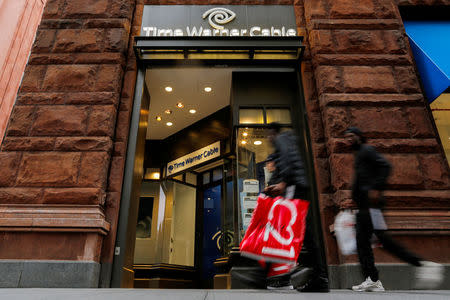 People walk past a Time Warner branch in the Manhattan borough of New York, U.S., October 22, 2016. REUTERS/Eduardo Munoz