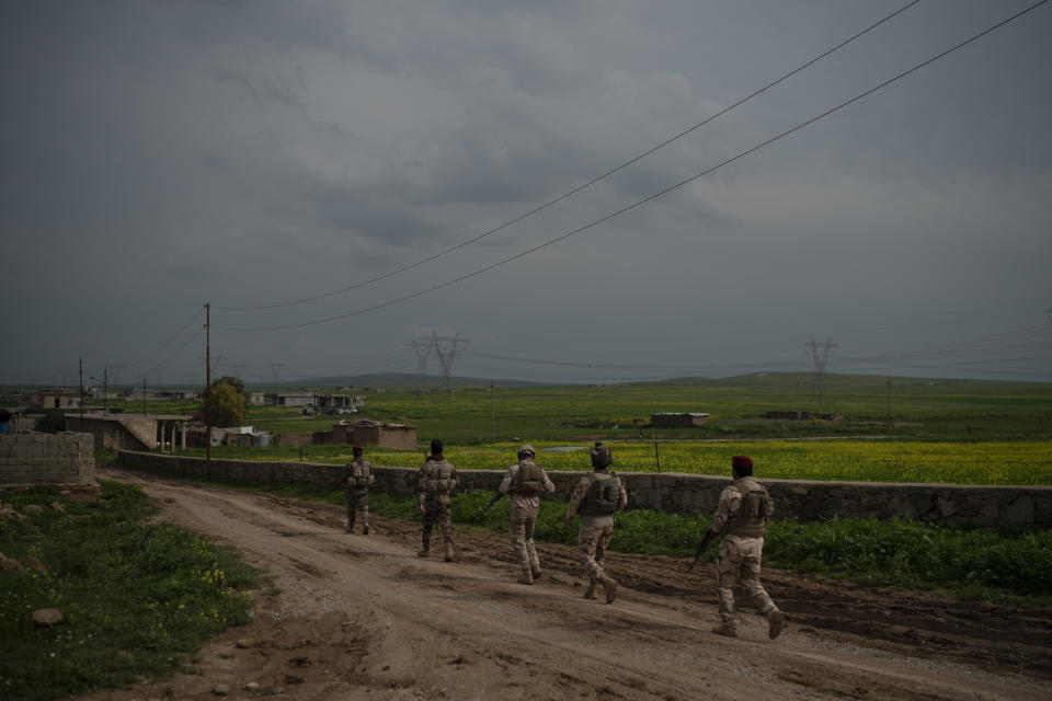 In this April 3, 2019 photo, Iraqi army 20th division soldiers patrol a village near Badoush, Iraq. "Although the territory once held by the so-called caliphate is fully liberated, Daesh fighters still exhibit their intention to exert influence and stage a comeback," said Maj. Gen. Chad Franks, deputy commander-operations and intelligence for the U.S.-led coalition, using the Arabic acronym for the group. (AP Photo/Felipe Dana)