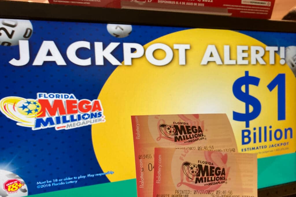 In this Wednesday, July 27, 2022 file photo, Mega Millions lottery tickets are shown at a lottery retailer in Surfside, Fla. A giant Mega Millions lottery jackpot ballooned to over $1 billion after no one matched all six numbers and won the top prize. (AP Photo/Wilfredo Lee, File)