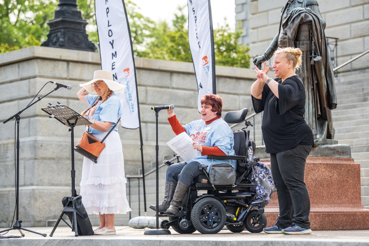 Mandy Halloran, left, director of public health and disability integration at Able South Carolina, and Dori Tempio, center, director of the organization's community outreach and consumer rights, address a crowd at a rally April 13 outside the South Carolina state Capitol. Speakers urged lawmakers to address barriers to independence for people with disabilities.