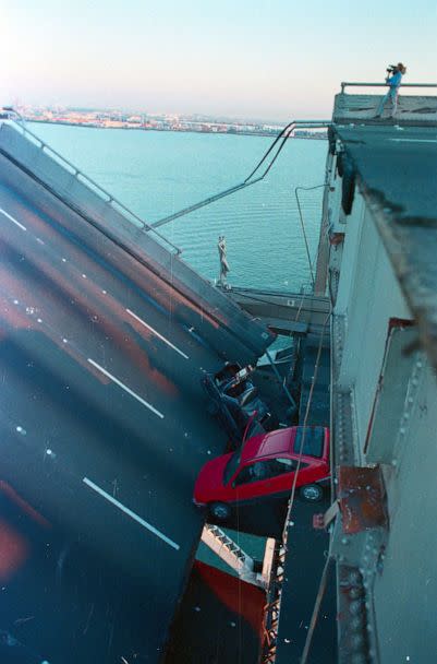 PHOTO: Rescue workers pull up car which was perched over section of bridge which collapsed in earthquake, in San Francisco, on Oct. 17, 1989. (Bettmann Archive/Getty Images, FILE)